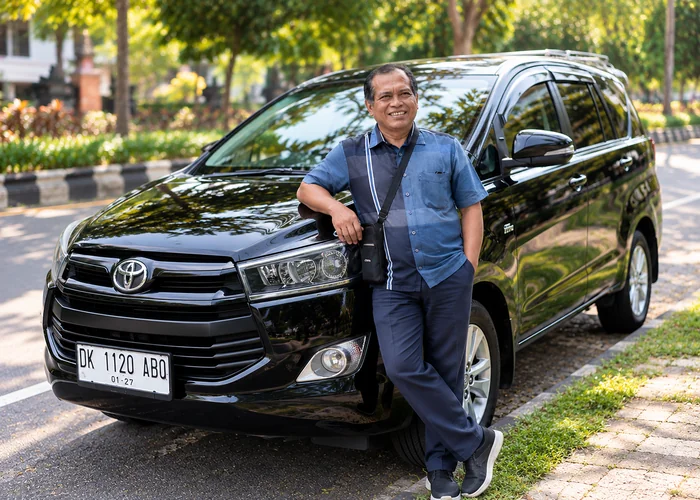 Gede Suparma, your local Bali host, beside his tour vehicle